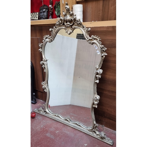 363 - Star lot : A fabulous silver coloured  Rococo style over mantle mirror. Housed in an ornate carved w... 