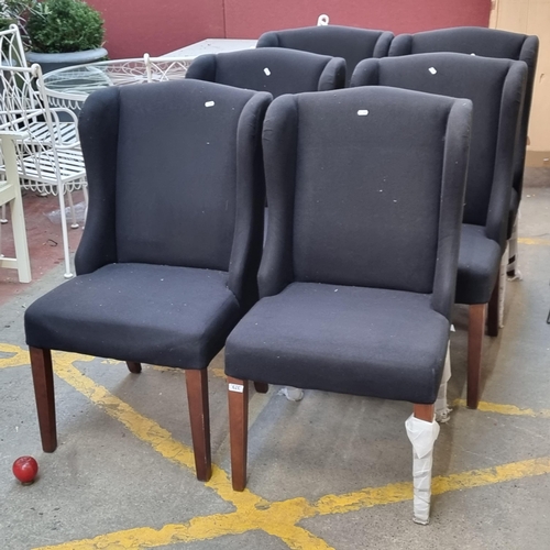 379 - Six handsome wingback designer dining chairs finished in a stylish black felt upholstery. All in goo... 