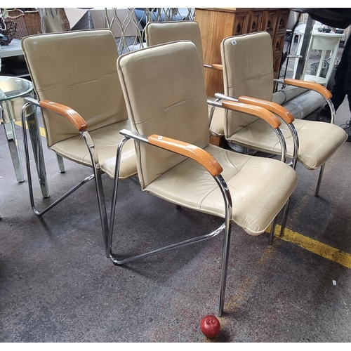 491 - A set of four stylish contemporary chairs with tubular chrome frames, polished wooden arm rests and ... 