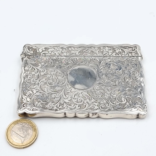 533 - An exceptional antique foliate engraved sterling silver card case, featuring a rim surround and a hi... 