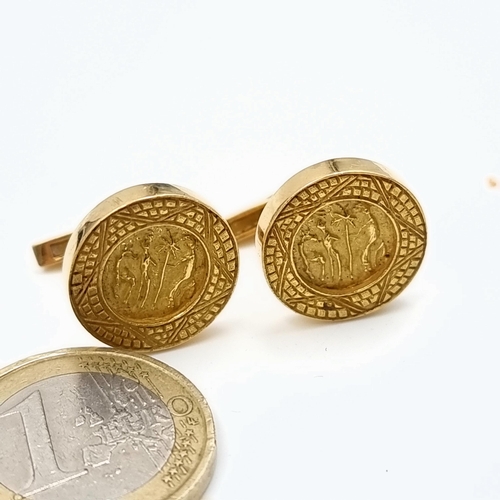 12 - Star Lot: A handsome pair of 18 carat gold cufflinks, each set with a bar setting and feature an unu... 