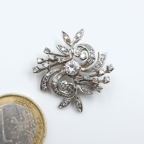 17 - Star lot : A striking example of a Diamond brooch, set intricately in white 14k gold. This truly fab... 