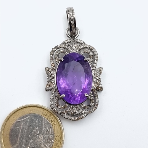 41 - A beautiful example of an Amethyst stone pendant, this pendant features a Diamond halo surround sett... 