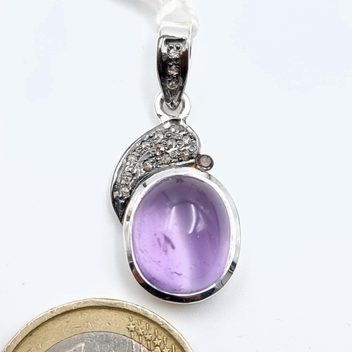 44 - A stunning Cabochon and Diamond sterling silver mounted pendant, of a central 7.13 carats and featur... 