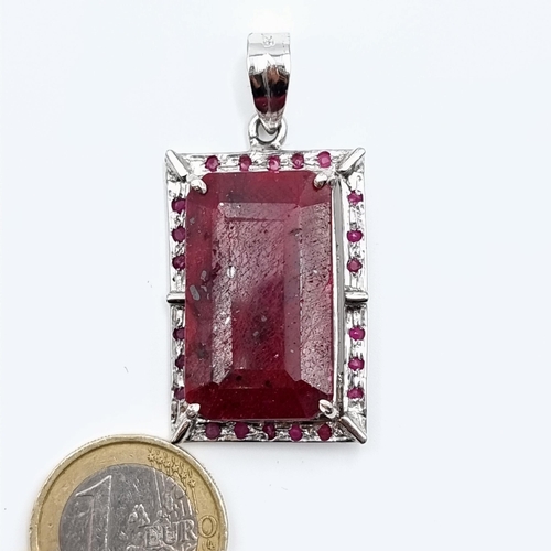 45 - A fine example of a Ruby facet cut sterling silver pendant, set with an intricate Ruby stone surroun... 
