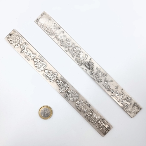 54 - A collection of two Tibetan silver Chinese bullion ingot silver scroll holders, depicting intricate ... 