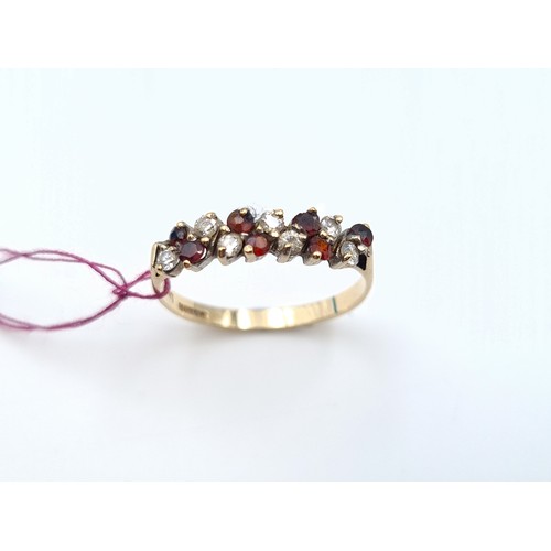 2 - Star Lot : A very attractive 9 carat Gold vintage 1960's Garnet and gem set ring, comprising of 14 b... 