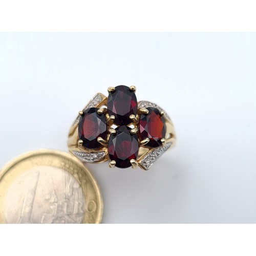 6 - Star Lot: A truly exquisite 9 carat Gold 1960's Diamond mounted four stone Garnet ring. This example... 