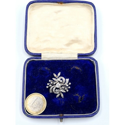 17 - Star lot : A striking example of a Diamond brooch, set intricately in white 14k gold. This truly fab... 