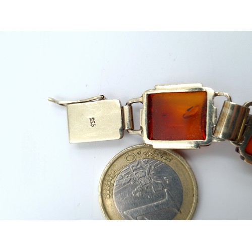 22 - A stunning example of an Art Deco German silver (stamped 935) Amber bracelet. This example features ... 