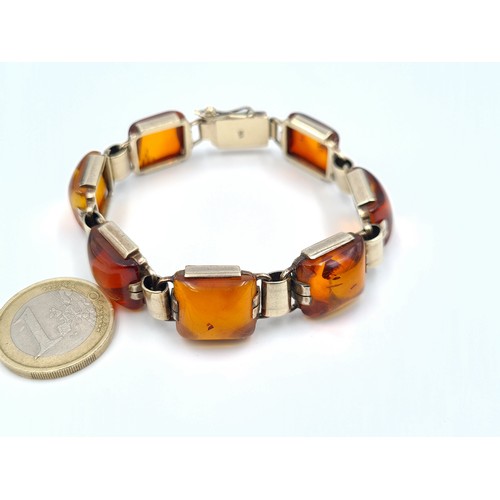 22 - A stunning example of an Art Deco German silver (stamped 935) Amber bracelet. This example features ... 
