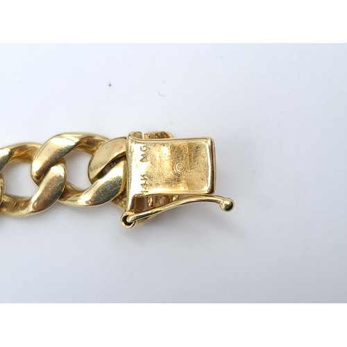 26 - Star Lot: A fine example of a thick and heavy 14 carat gold link bracelet, set with double safety cl... 