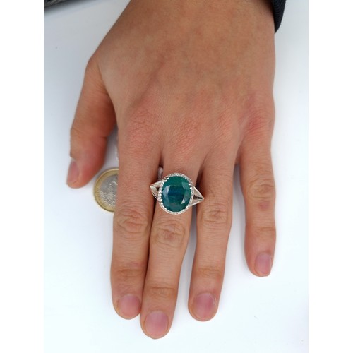 35 - Star Lot : A striking example of a Green Nephrite and Diamond sterling silver ring, set with a claw ... 
