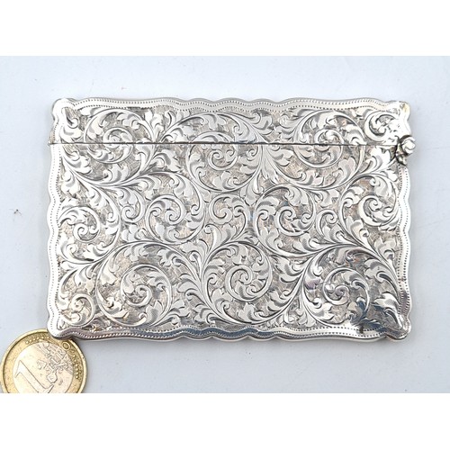533 - An exceptional antique foliate engraved sterling silver card case, featuring a rim surround and a hi... 