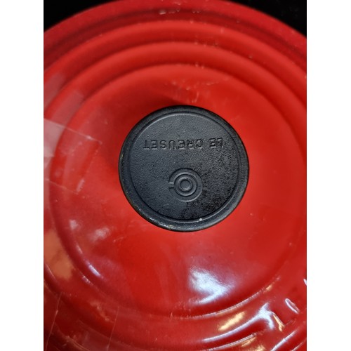 154 - A heavy cast iron Le Creuset casserole pot. Designed in a graduating red enamel with a heat resistan... 