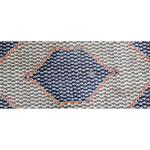 342 - A handwoven Anatolian Turkish rug in shades of blue and orange with a geometric border and central l... 