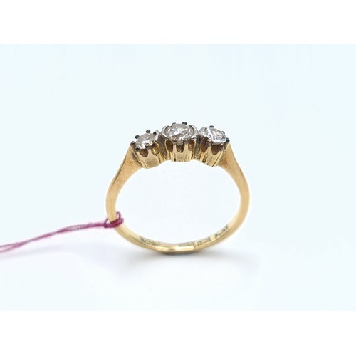 20 - Star lot : A fine 18ct yellow gold three stone diamond ring. This ring showcases three bright brilli... 