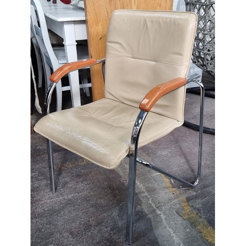 491 - A set of four stylish contemporary chairs with tubular chrome frames, polished wooden arm rests and ... 