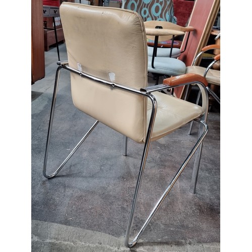 491 - A set of four stylish contemporary chairs with tubular chrome frames, polished wooden arm rests and ... 