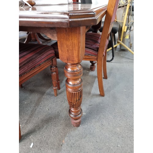 912 - Star lot : A handsome Victorian dining suite comprising of a table with a centre leaf for extension ... 