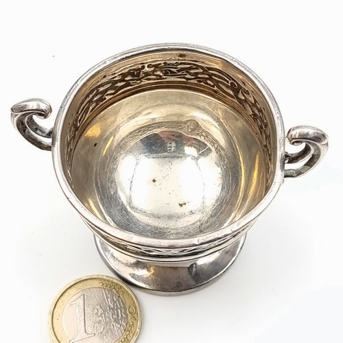 518 - A fine example of an antique sterling silver challenge cup, this cup features dual scroll handles an... 