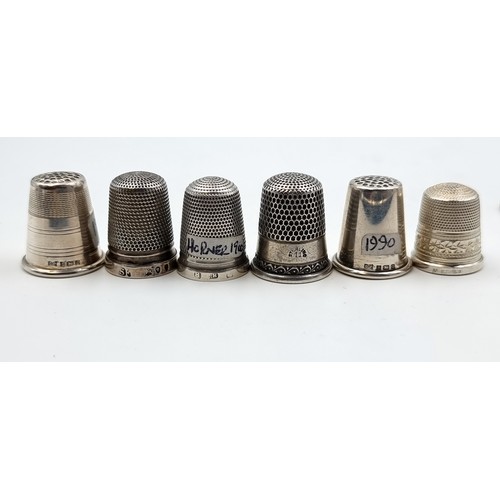 524 - A collection of six sterling silver thimbles. Of particular interest, a Thimble by the notable maker... 