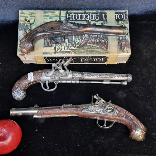 121 - A selection of three highly ornate heavy quality replica flintlock pistols. Including two Spanish ma... 