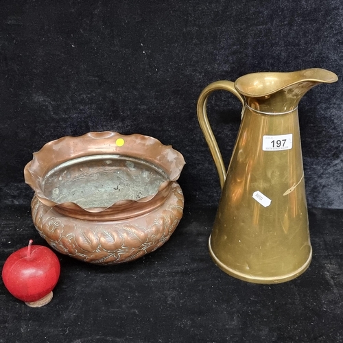 197 - Two Arts and Crafts items including a Joseph Sankey & Sons brass pitcher and a hand-hammered floral ... 