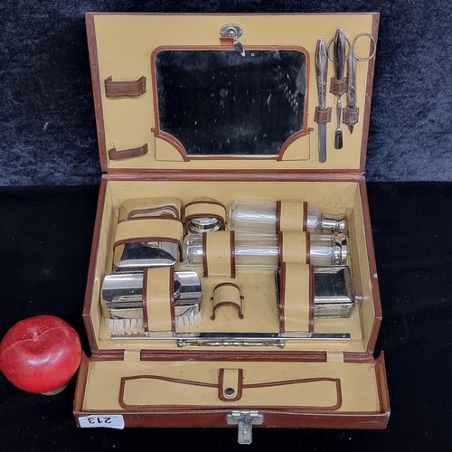 213 - A top quality gentleman's travelling kit featuring cologne bottles, brushes and mirror. All set in a... 