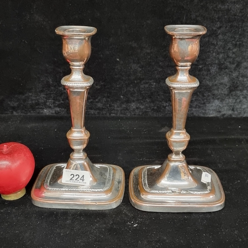 224 - A pair of antique silver-plated candlesticks highly polished with green felt base.