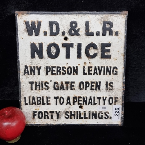 226 - A cast metal railway notice sign with a fine notice in black relief text against a white background.