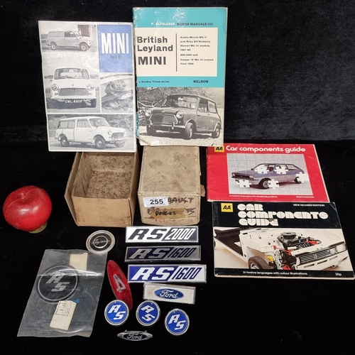 255 - A lot containing eleven vintage car badges including the Ford Capris along with other Ford examples.... 