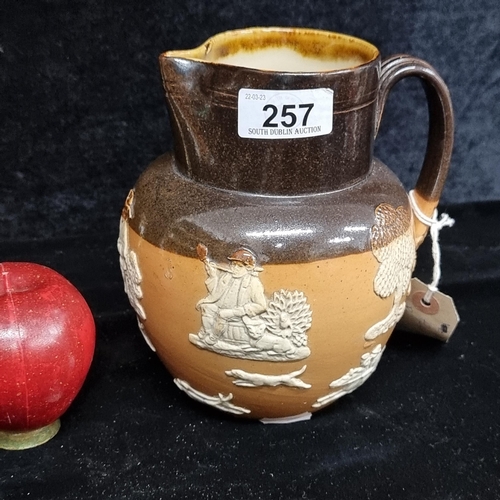 257 - A gorgeous antique Royal Doulton lambet ware pitcher featuring harvest and hunting scenes. In very g... 