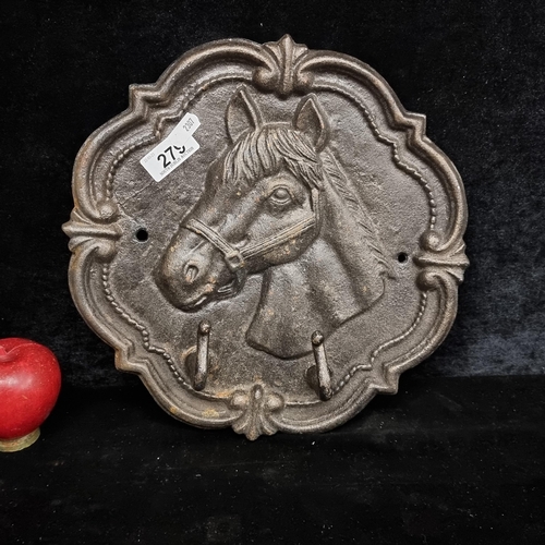 279 - A cast metal wall mounting coat hook rack. Featuring a relief horse and a decorative surround. With ... 