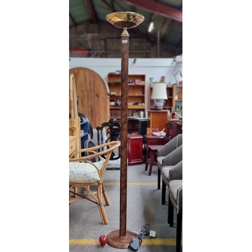 556 - A floor standing lamp in an Art Deco style with burled wood effect stem and bowl uplighter. Supplied... 