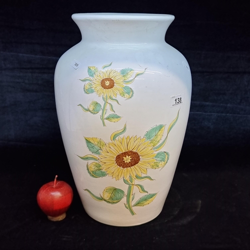 138 - A very large floor standing urn shaped vase illustrated with cheerful sunflowers. H39cm