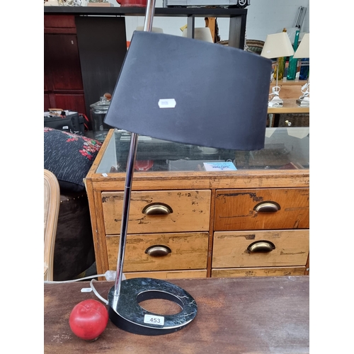 453 - An EGLO table lamp with an unusual polished chrome base with pierced detail. Topped with a matte bla... 