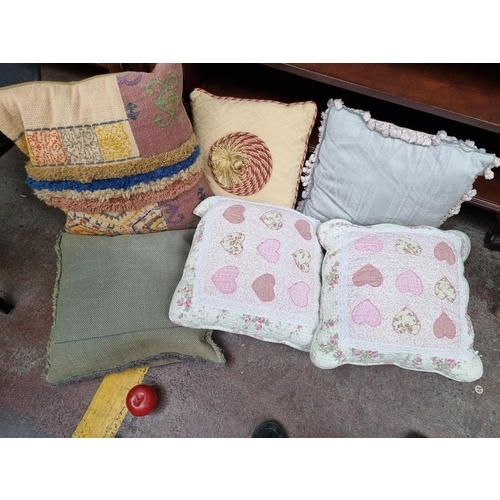 451 - An eclectic selection of throw cushions in a variety of styles. Including one really stunning exampl... 