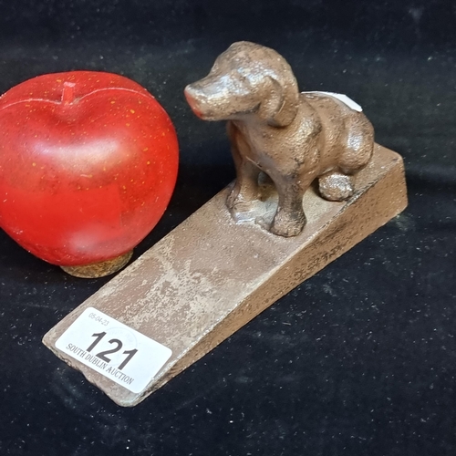 121 - A heavy cast metal door stop in the form of a loyal dog.