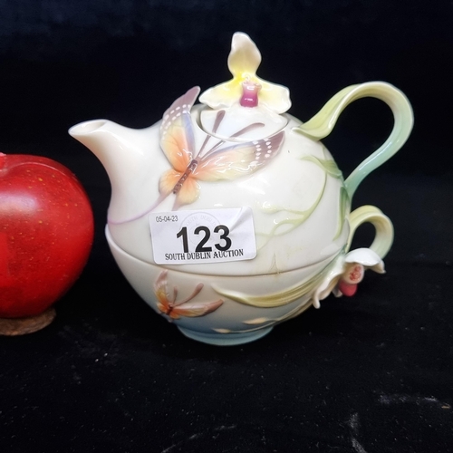 123 - A vintage Franz Pottery stackable teacup and teapot with charming floral and butterfly design in hig... 