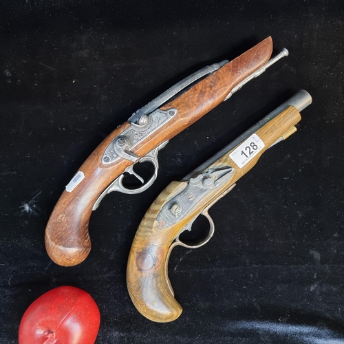 128 - Two replica flint lock pistols with wooden handles.