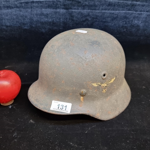 131 - Star Lot : A genuine World War II M35 German Luftwaffe steel helmet with leather insert. original de... 