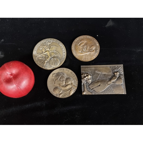 275 - A selection of four bronze and brass tokens. These are large vintage examples. Including a solid bro... 