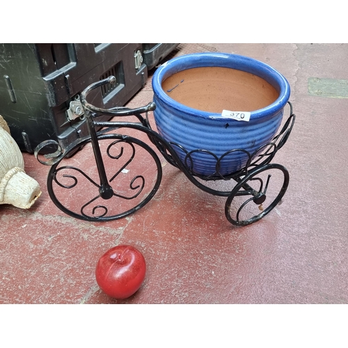 370 - A delightful planter with wrought metal stand in the form of a tricycle and a bright blue glaze terr... 