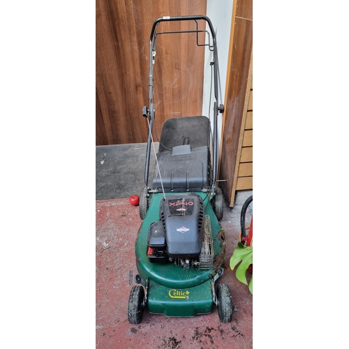 387 - A Sprint XP40 Celtic petrol lawnmower made by Briggs & Stratton. Some rust damage to the body but in... 