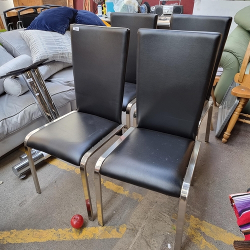 389 - Four chic modern dining chairs with polished chrome legs and black leather seat with high back.