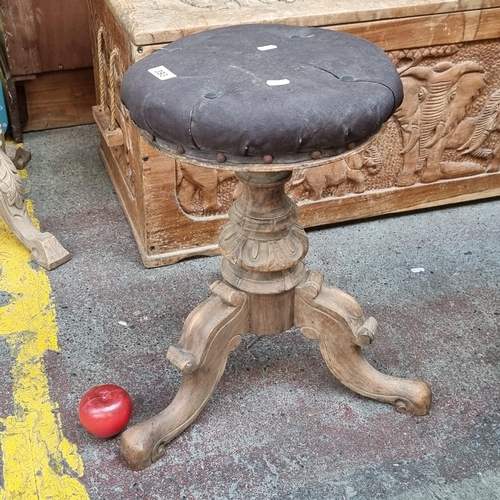 393 - A fabulous antique piano stool with swivel tool and elaborately carved tripod base.