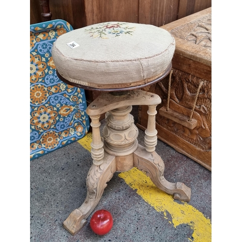 394 - A fine example of an antique piano stool. This well crafted example boasts a lavishly carved base an... 