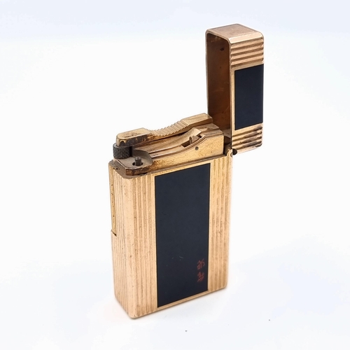 501 - A handsome example of a heavy vintage singed DuPoint of Paris gold coloured metal gas lighter, featu... 