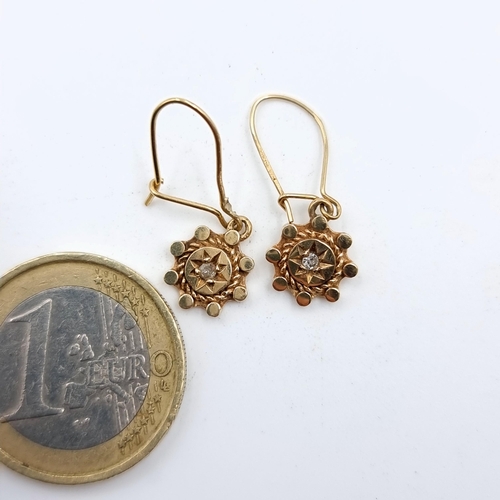 506 - A beautiful pair of antique 9 carat gold Diamond drop earrings, featuring a fabulous sun burst desig... 